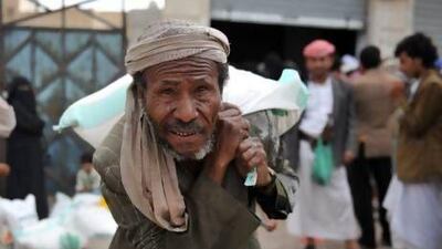 A Yemeni man carries a sack of food aid provided by the UAE at a food distribution center in Sana'a, Yemen. The United Nations has warned that Yemen is on the brink of a catastrophic food crisis with 10 million people without enough food to eat and one in three children severely malnourished. Courtesy EPA
