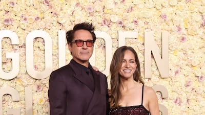 Robert Downey Jr and his wife Susan Downey in matching plum. Getty Images via AFP