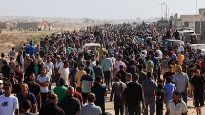 Palestinians seeking aid gather near an aid distribution site run by the US-backed Gaza Humanitarian Foundation, in Rafah. Reuters