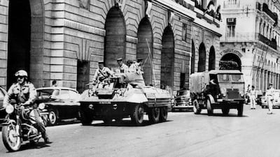 A military biker and a tank drive in front of a truck carrying the French former general Andre Zeller in Algiers on May 6, 1961. Zeller had been arrested over involvement in a putsch on April 22. Photo: AFP