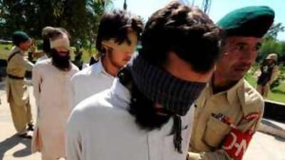 Pakistani soldiers guard suspected Afghan militants paraded for the media in the troubled north-western region of Bajaur.