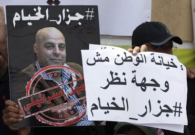 In this file photo members of the Lebanese Shiite Amal movement on September 15, 2019, hold a photograph of Amer Fakhoury, during a demonstration in front of the former Israeli-run prison of Khiyam on the border with Israel, to demand his trial. AFP