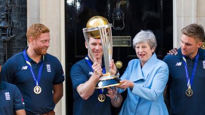 British prime minister Theresa May and England captain Eoin Morgan pose with the World Cup trophy. EPA