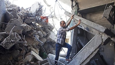 Palestinian Tafiq al Halabi in his heavily damaged home by the rubble of the estroyed home where eight members of the Al Hajj family were killed in a strike early morning in Khan Younis refugee camp, southern Gaza Strip on July 10, 2014. Heidi Levine for The National