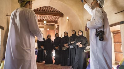 A group of female Omani diploma students are taken to Nakhal Fort in north Oman to receive lessons in being a tour guide. Sebastian Castelier for The National