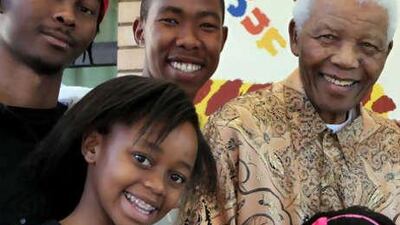 Former South African president Nelson Mandela, top right, with his great-grandson Thembela Mandela, top left, grandson Mbuso Mandela, top centre, great-granddaughter Zenani Mandela, in the foreground, at the Mandela foundation in Johannesburg.