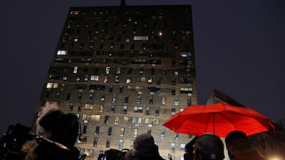 Onlookers gaze up at the building where the fire broke out. Reuters
