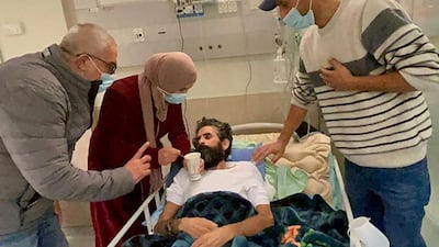 Hisham Abu Hawash lies in a hospital bed after ending his hunger strike on January 4. AFP