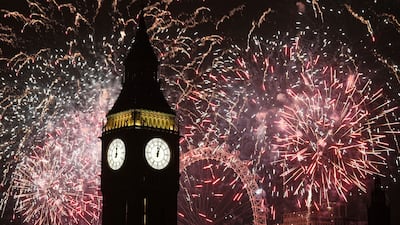 Fireworks light up the sky over Elizabeth Tower, also known as Big Ben, and the London Eye in central London during the New Year celebrations. PA