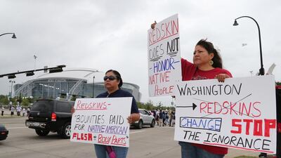 Issues, such as protests by Native Americans such as Diana Parton, left, and Yolonda Bluehorse about Washington’s nickname, has not slowed fans anticipation for the 2014/15 season. Matthew Emmons /USA Today
