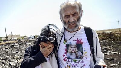 Jerzy Dyczynsk (R) and Angela Rudhart-Dyczynski from Australia react as they arrive on July 26, 2014 at the crash site of the Malaysia Airlines Flight MH17 to look for their late daughter Fatima, near the village of Hrabove (Grabovo), in the Donetsk region. AFP Photo