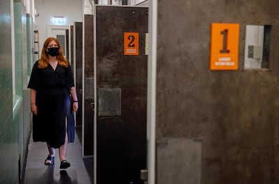 Jen Kavanagh, museum curator, poses for a photograph with cell doors at the Bow Street Police Museum in London. Reuters/John Sibley