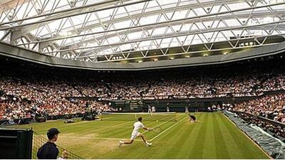 Wimbledon's new £80million new roof is closed as Andy Murray and Stanislas Wawrinka play long into the London night.