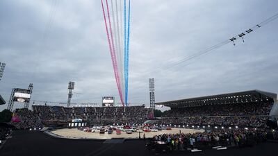 The Red Arrows, the Aerobatic Team of Britain's Royal Air Force, fly over the stadium. AP