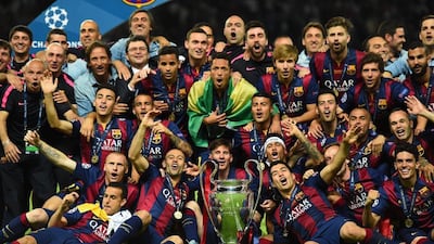 Barcelona celebrate victory with the trophy after the Uefa Champions League Final against Juventus at Olympic Stadium on June 6, 2015 in Berlin, Germany. (Photo by Laurence Griffiths/Getty Images)