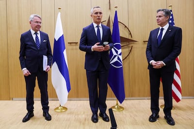 Nato Secretary General Jens Stoltenberg, centre, speaks as Finnish Foreign Minister Pekka Haavisto, left, prepares to hand accession documents to US Secretary of State Antony Blinken during Finland’s joining ceremony. Reuters