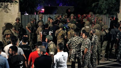 Lebanese security stand near the site where a drone was said to have crashed in a stronghold of the Lebanese Hezbollah group, in a southern suburb of Beirut, Lebanon. AP Photo