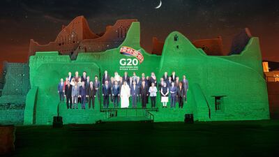 The "Family Photo" for the annual G20 Summit World Leaders is projected onto Salwa Palace in At-Turaif, one of Saudi Arabia’s UNESCO World Heritage sites, in Diriyah, Saudi Arabia. The Saudi G20 Presidency Media via Reuters