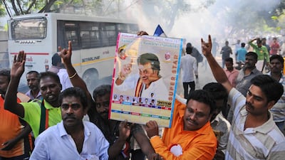 Indian movie superstar Rajinikanth fans burn firecrackers and hold his photograph after his announcement to launch his own political party. Rajinikanth is entering politics in his southern Indian state with a plan to launch his own party, calling it his duty. R.Parthibhan / AP photo