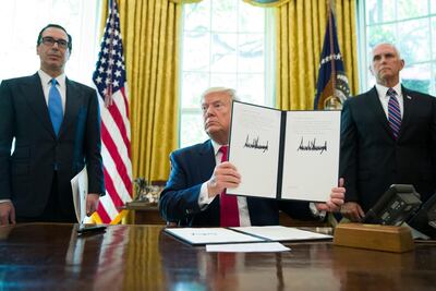 President Donald Trump holds a signed executive order to increase sanctions on Iran, with Treasury Secretary Steve Mnuchin, left, and Vice President Mike Pence. AP Photo