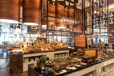 All-day dining at the Hilton Palm Jumeirah, where the hotel aims to reduce food waste by implementing green initiatives. Antonie Robertson / The National