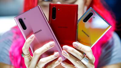 A woman holds different models of Samsung Galaxy Note 10 during the launch event at the Barclays Center in Brooklyn, New York, US. Reuters
