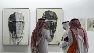 Visitors study the works on display during Art Dubai at Madinat Jumeirah. Pawan Singh / The National