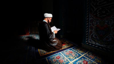 Shiite cleric Ali Al Atabi reads from the Quran in the vicinity of Imam Ali shrine in Iraq's central city of Najaf. AFP