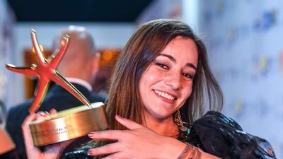 Amira Hilda Douaoud poses with her award for Best Arabic Narrative Movie. AFP