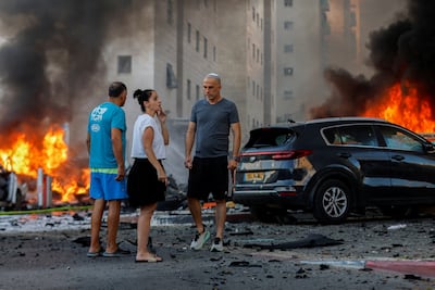 Vehicles burn in Ashkelon after Hamas fired rockets from Gaza. Reuters