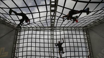 10. NET: Elite athletes tackle the A-frame cargo net in the XDubai Spartan Race at Al Ghazal Golf Club, Abu Dhabi, in September 2017. Ravindranath K / The National