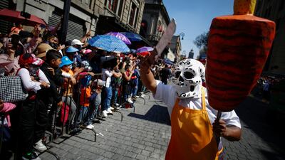 A participant performs as a taquero during the annual Day of the Dead parade in Mexico City. Reuters