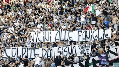 Juventus supporters show a banner reading "Close to the families hit by the earthquake" to honour the victims of Wednesday's earthquake that hit central Italy. Angelo Carconi / AP