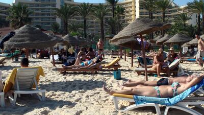 Tourists relax on the beach in the Tunisian resort town of Sousse, where gunmen killed at least 27 people in an attack on June 26, 2015. Bechir Bettaieb / AFP /October 31, 2013
