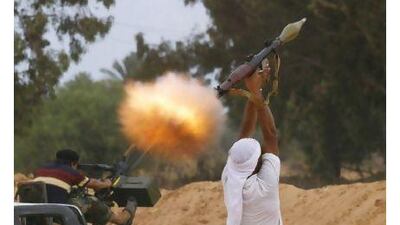 An anti-Qaddafi fighter fires an RPG-7 during fighting close to the centre of Sirte yesterday. Anis Mili / Reuters