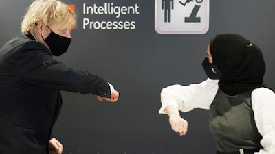 Boris Johnson greets an employee. AP Photo