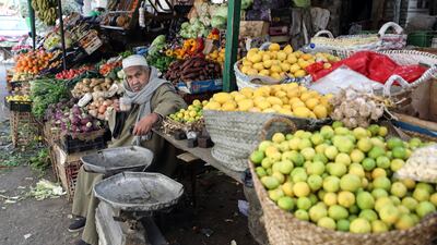 A seller waits for customers at his stall with fruit and vegetables at a market in Cairo. EPA