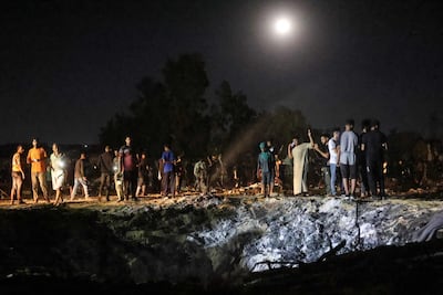Palestinians gather at the site of an Israeli strike at the Al Mawasi camp in Khan Younis, southern Gaza Strip. AFP