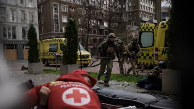 Ukrainian troops run for cover from explosions, during a Russian attack in central Kharkiv. AP