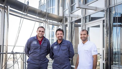 Hammond with Bashar Kassab, senior director facilities management at Burj Khalifa, and Pieter van der Walt, a project manager, after cleaning windows.