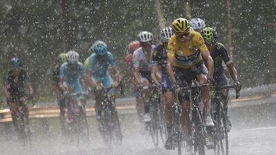 Britain’s Chris Froome, wearing the overall leader’s yellow jersey, climbs towards Andorra Arcalis in pouring rain and hail during the ninth stage of the Tour de France cycling race over 184.5km with start in Vielha Val d’Aran, Spain, and finish in Andorra Arcalis, Andorra, Sunday, July 10, 2016. Christophe Ena / AP Photo