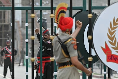 Pakistani Rangers, left, and Indian Border Security Force personnel perform during the beating retreat ceremony at the Attari-Wagah border between Pakistan and India. AFP