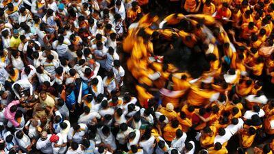 Devotees dance after breaking a clay pot containing curd during celebrations to mark the Hindu festival of Janmashtami in Mumbai.