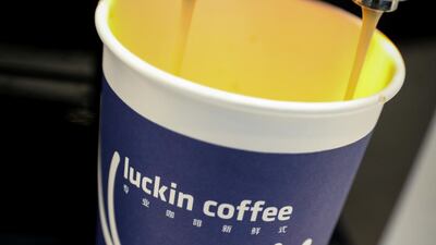 A cup of 'Luckin Coffee,' coffee is poured during the company's initial public offiering at the Nasdaq Market site in New York. The company raised $645 million through the IPO and subsequently tapped markets for a further $778m to fund growth in January. Reuters