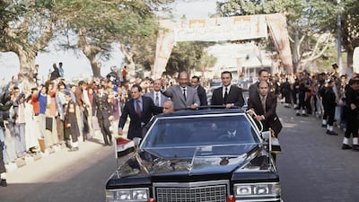 Anwar Sadat, then Egyptian president, in a Cadillac in December 1978. His limited-edition limo is now for sale. Bill Foley / AP Photo