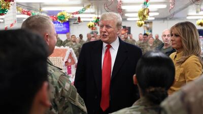 US President Donald Trump and first lady Melania Trump greet military personnel at the dining facility during an unannounced visit to Al Asad Air Base, Iraq. Reuters
