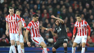 Liverpool's Joe Allen controls the ball surrounded by Stoke City players during the first leg of the English League Cup semifinal soccer match between Stoke City and Liverpool at the Britannia Stadium, Stoke on Trent, England, Tuesday, Jan. 5, 2016. (AP Photo/Rui Vieira)