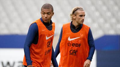 Kylian Mbappe, left, is away on international duty with France but has completed his season-long loan move to PSG. Yoan Valat / EPA