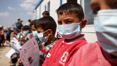 Displaced Syrian children and their parents attend a workshop on Covid-19 organised by medical volunteers at a camp near the town of Atme, close to Syria’s border with Turkey. AFP