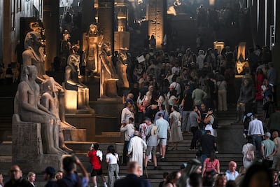 Visitors walk among statues displayed on the Grand Staircase of the museum. EPA